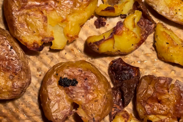 overhead of crispy potatoes on a baking tray