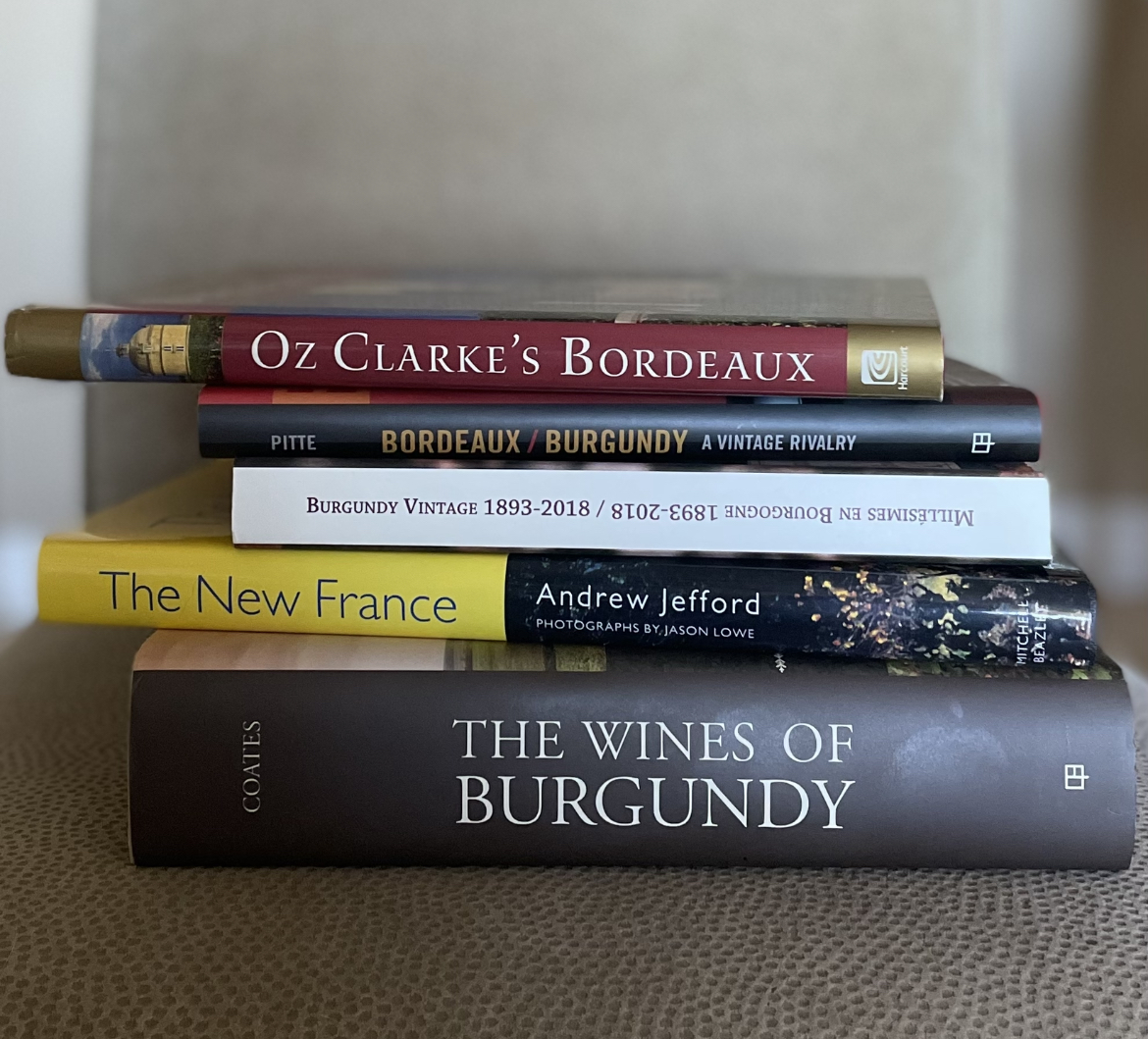 stack of burgundy and bordeaux text books