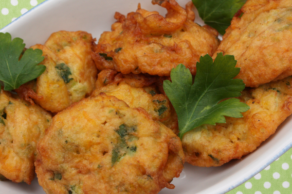 a plate of golden brown zucchini fritters