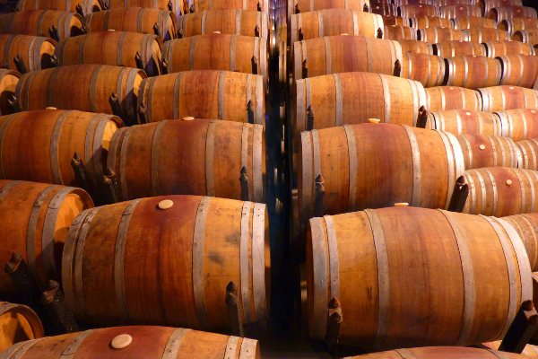 overhead view of rows of wine barrels in a cellar