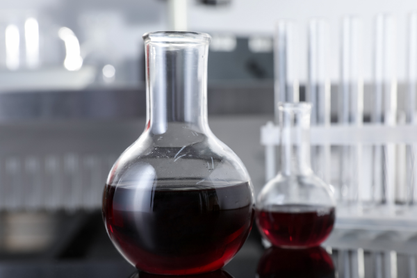 Glass Flasks with Red Liquid on Table in Laboratory