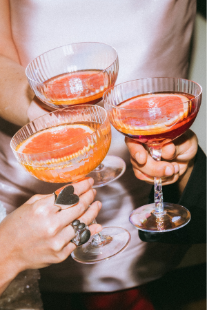 3 coups with oranges clinking together