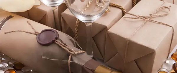 boxes and wine bottles wrapped in brown, craft paper